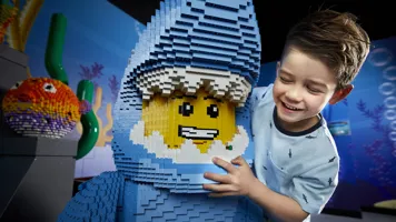 child with lego figure