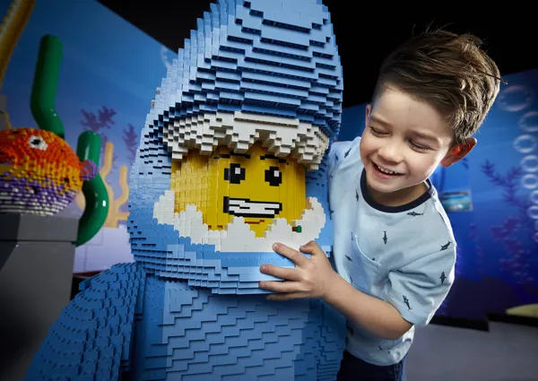 child with lego figure